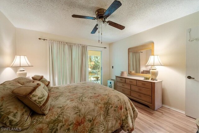 bedroom with a textured ceiling, light hardwood / wood-style flooring, ceiling fan, and access to outside