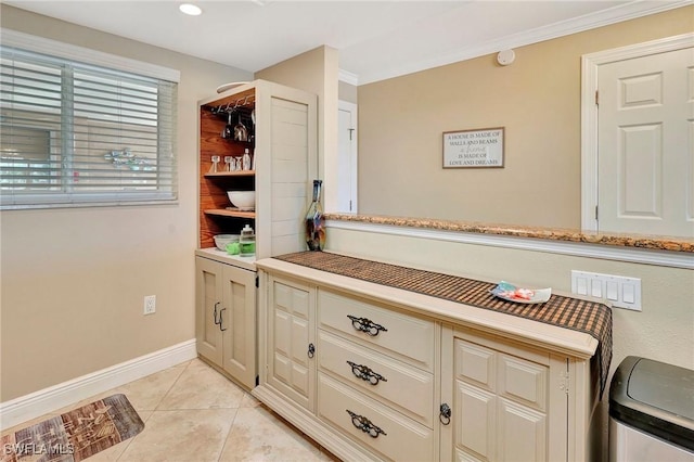 interior space with light tile patterned floors and cream cabinetry