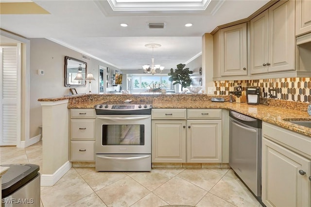 kitchen featuring appliances with stainless steel finishes, ornamental molding, kitchen peninsula, decorative light fixtures, and cream cabinetry