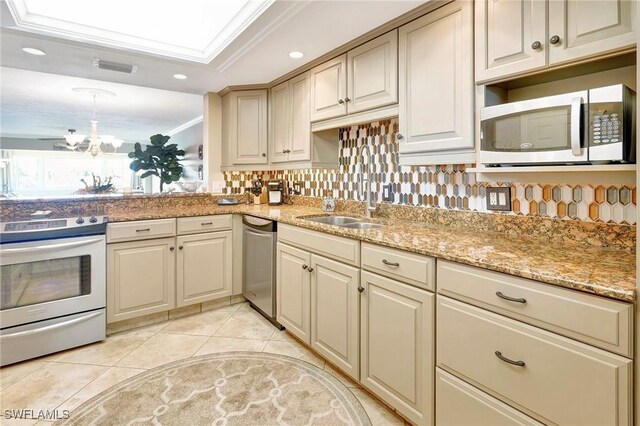 kitchen with pendant lighting, sink, crown molding, stainless steel appliances, and light tile patterned flooring