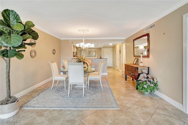 dining area featuring an inviting chandelier, ornamental molding, and light tile patterned floors