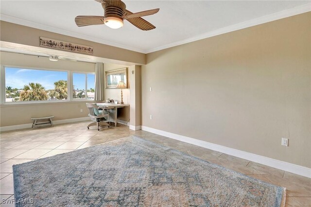 unfurnished office with ceiling fan, ornamental molding, and light tile patterned floors