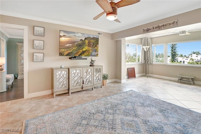 living area with light tile patterned flooring, ceiling fan, and ornamental molding