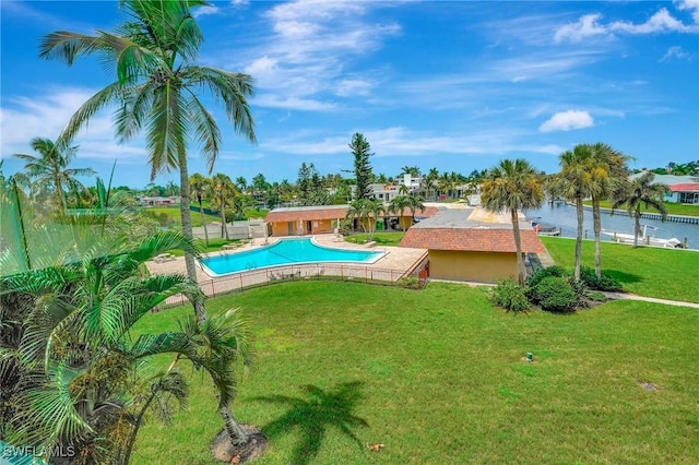 view of pool featuring a water view and a yard