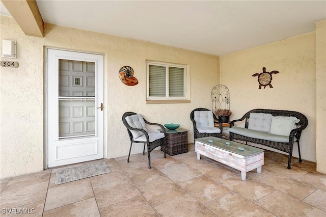 property entrance with a patio area and outdoor lounge area