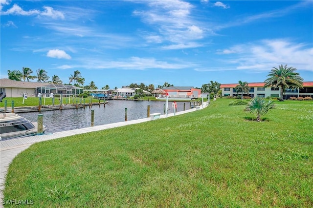 view of dock featuring a water view and a yard