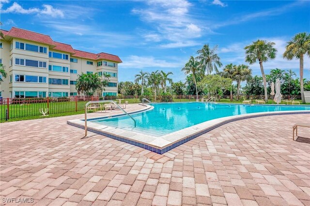 view of pool featuring a yard