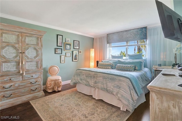 bedroom with crown molding and dark hardwood / wood-style flooring