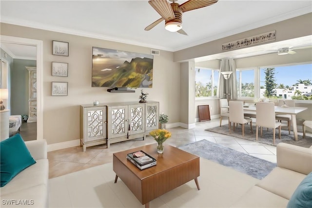 living room with crown molding, ceiling fan, and light tile patterned flooring