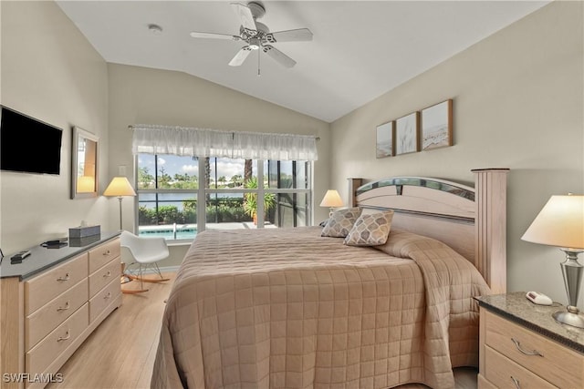 bedroom featuring ceiling fan, vaulted ceiling, and light hardwood / wood-style flooring