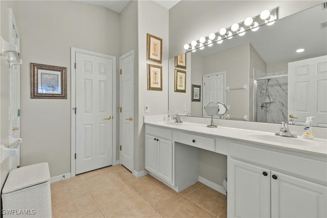 bathroom with walk in shower, tile patterned floors, and vanity