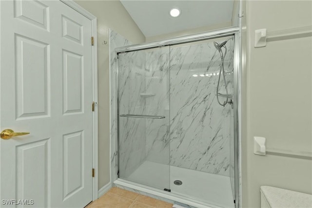 bathroom with tile patterned flooring and a shower with door