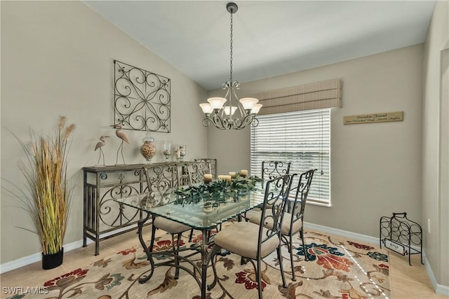 dining area featuring lofted ceiling and a notable chandelier