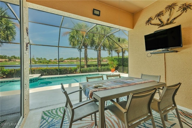 view of pool featuring a water view, a patio, and glass enclosure