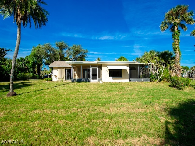 view of front of home featuring a sunroom and a front yard