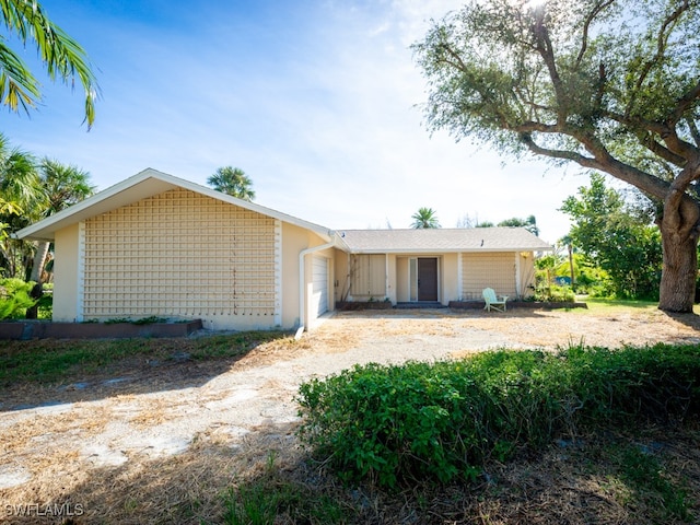 rear view of house featuring a garage