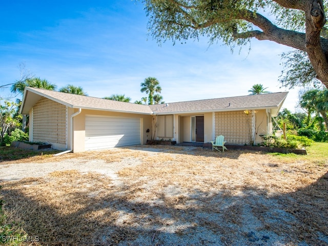 ranch-style house featuring a garage