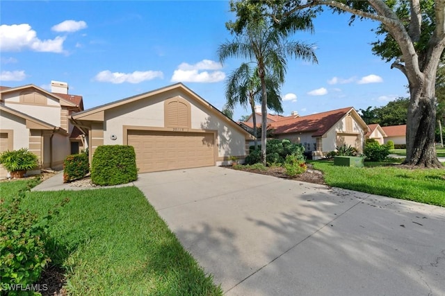 view of front of property with a garage and a front lawn