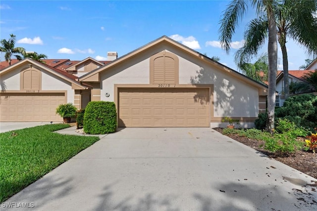 view of front of property with a garage, concrete driveway, and stucco siding