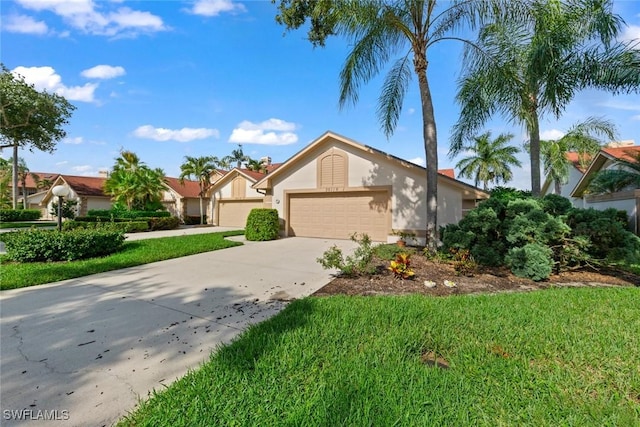 view of front of house featuring driveway, an attached garage, a front yard, and stucco siding