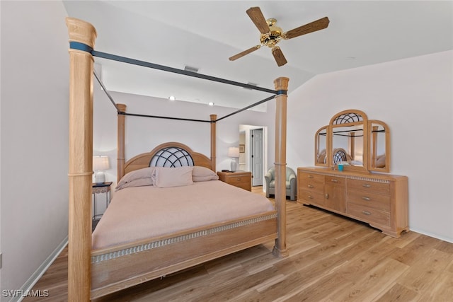 bedroom featuring vaulted ceiling, light hardwood / wood-style floors, and ceiling fan