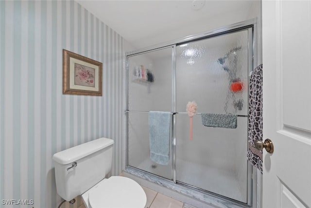 full bath with a shower stall, toilet, and wallpapered walls