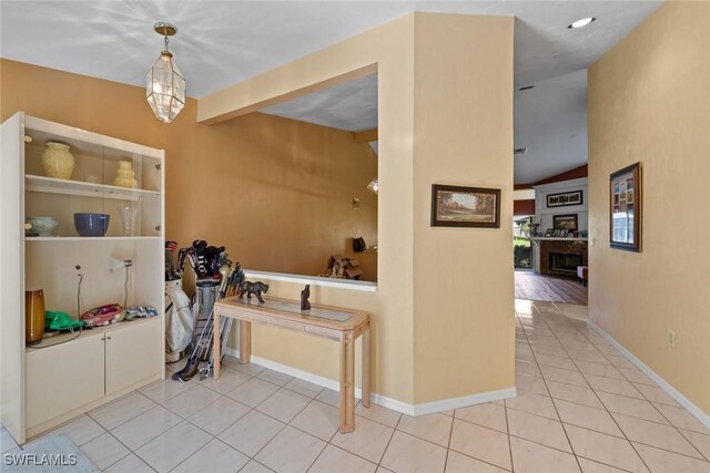 interior space featuring light tile patterned flooring and vaulted ceiling with beams