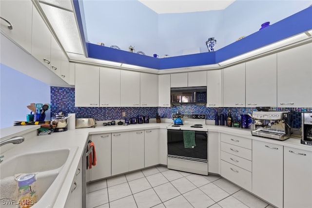 kitchen featuring sink, white electric range, white cabinets, and backsplash