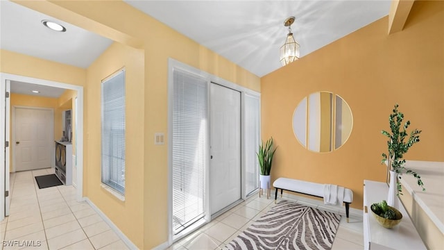 interior space with baseboards, a notable chandelier, and tile patterned floors