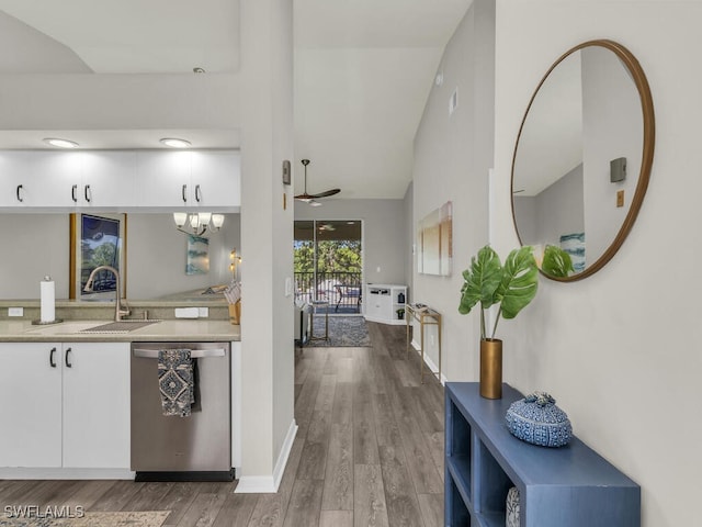 kitchen with sink, ceiling fan, white cabinetry, hardwood / wood-style floors, and stainless steel dishwasher