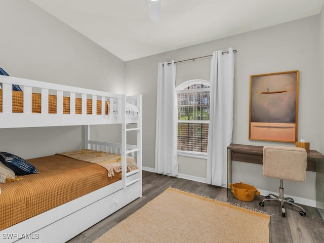 bedroom with lofted ceiling and dark hardwood / wood-style floors