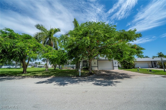 obstructed view of property featuring a front yard