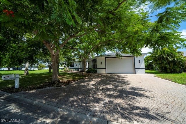 view of front of home with a garage and a front yard