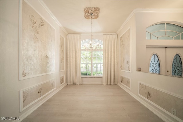 corridor with ornamental molding, hardwood / wood-style flooring, and a chandelier