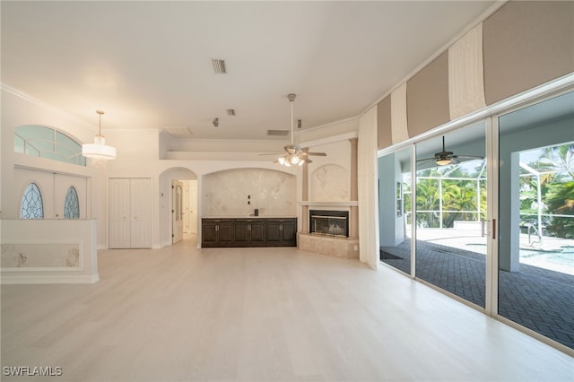 unfurnished living room featuring ceiling fan and light hardwood / wood-style flooring