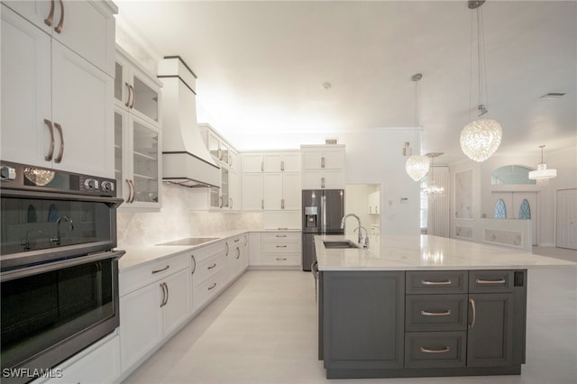 kitchen with double wall oven, white cabinets, decorative backsplash, custom range hood, and black electric stovetop