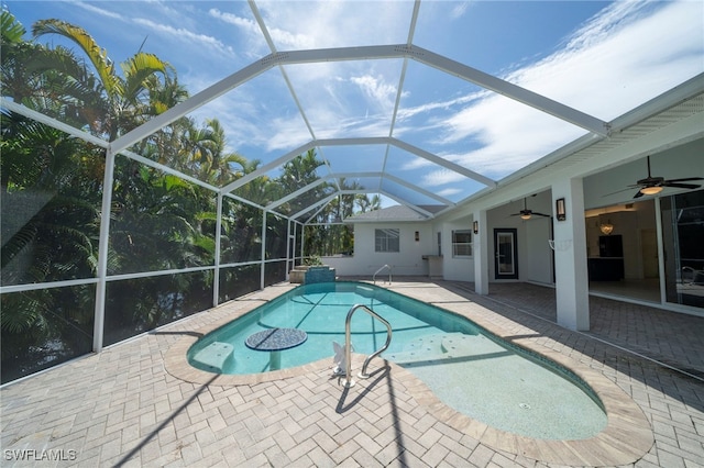 view of pool with a lanai, a patio, and ceiling fan