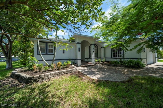 mediterranean / spanish home featuring a front lawn