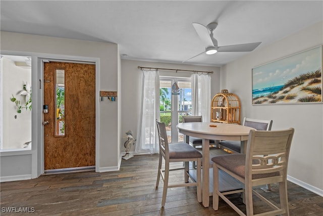 dining space with dark wood-type flooring and ceiling fan