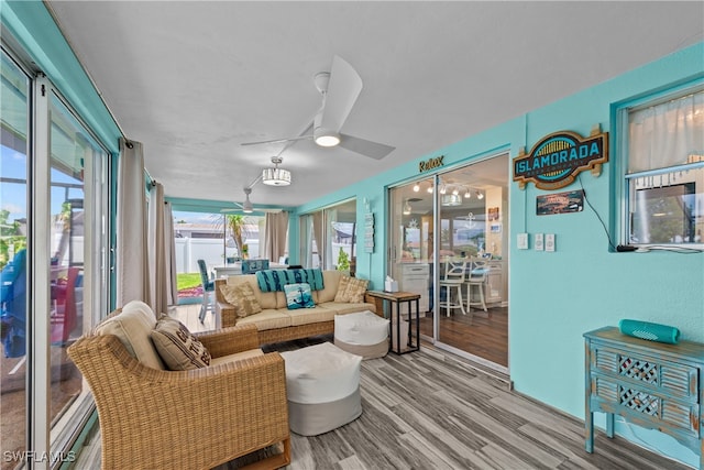 living room featuring hardwood / wood-style floors and ceiling fan