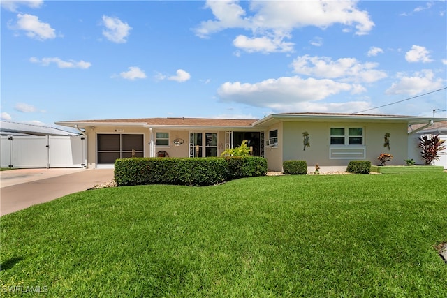 ranch-style house with a garage and a front lawn