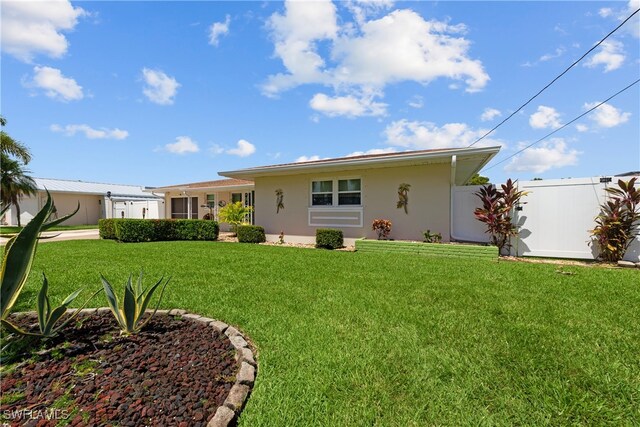 rear view of house with a yard