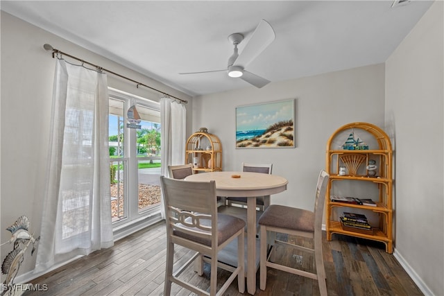 dining room with ceiling fan and dark hardwood / wood-style flooring