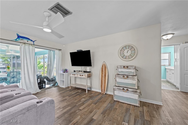 living room with hardwood / wood-style floors and ceiling fan