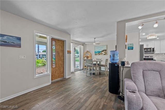 living room featuring dark hardwood / wood-style floors and ceiling fan