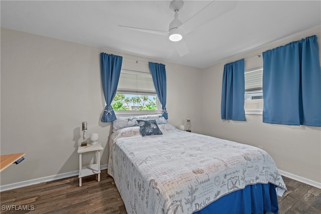 bedroom with dark hardwood / wood-style floors and ceiling fan