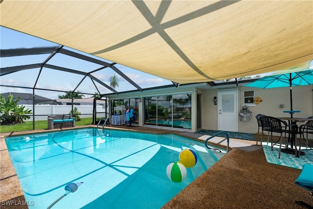 view of swimming pool with a patio and glass enclosure