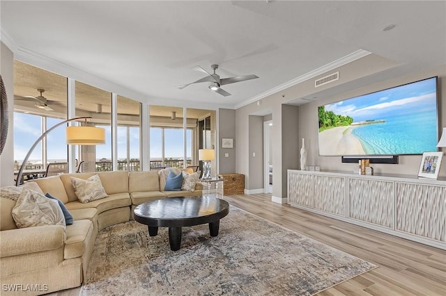 living room featuring ceiling fan, light hardwood / wood-style flooring, and crown molding