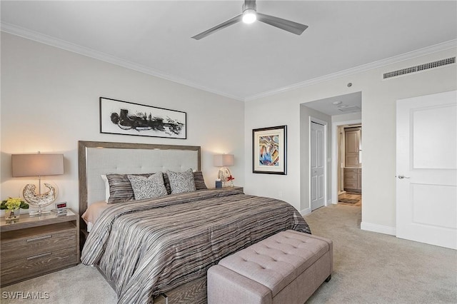 bedroom with ensuite bath, light carpet, crown molding, and ceiling fan