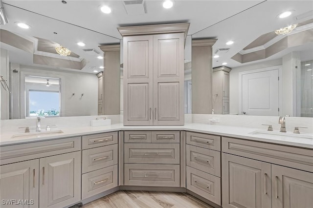 bathroom featuring hardwood / wood-style floors, vanity, and ornamental molding